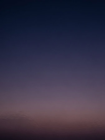 Across showing deep twilight sky gradient with subtle purple and dark blue hues transitioning smoothly across the frame creating a serene and atmospheric backdrop...の素材