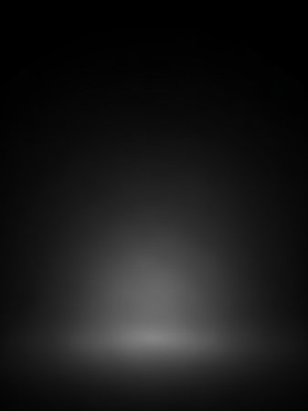 A dark, gradient studio background with a soft, bright light emanating from the bottom center, creating a subtle glow and a sense of depth.の素材
