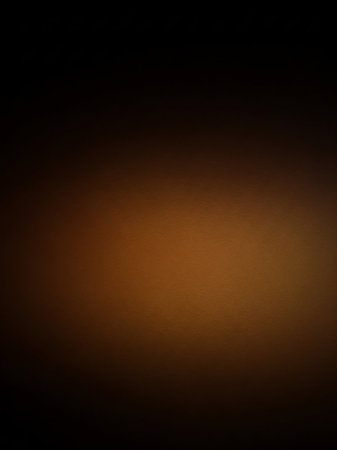 A dark, textured background transitioning from deep brown to black, with a subtle, soft luminous glow in the lower central area.の素材