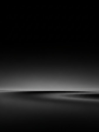 A dark, minimalist abstract scene subtle horizontal light reflecting on a smooth, rippling surface with soft shadows.の素材