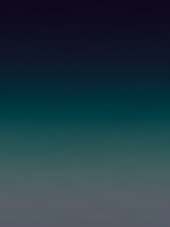 A smooth vertical gradient transitions from deep navy blue at the to teal and then to a muted gray at the bottom.の素材