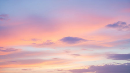 Purple showing pastel pink and purple clouds in a soft sky at dusk or dawn with subtle hues of orange and yellow streaking through the atmosphere creating a serene...の素材