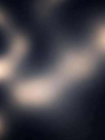 Warm showing softly blurred abstract background with warm light streaks on a dark navy blue canvas evoking a sense of calm and mystery. resolutionの素材