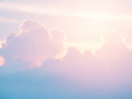 Soft pink and blue pastel clouds are illuminated by bright golden sunlight. Fluffy cumulus formations create a dreamy, ethereal atmospheric glow.の素材