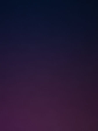 A smooth gradient transitions from deep navy blue at the to a rich dark purple at the bottom, creating a subtle abstract background.の素材