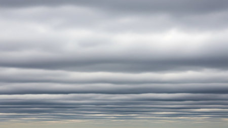 (1744) showing layered stratocumulus clouds forming horizontal wavy bands across a gray sky creating a textured and patterned atmospheric background.の素材