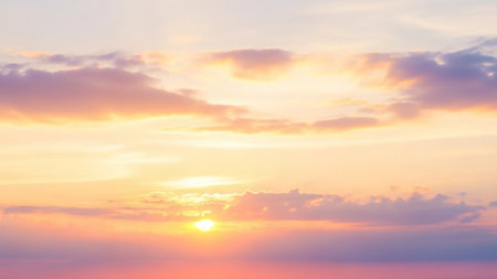 A serene sky painted in soft pastel shades of pink and orange, with gentle clouds and a faint sun glow on the horizon, creating a tranquil and dreamy atmosphere.の素材