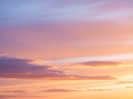 Clouds showing soft pastel sunset sky with wispy clouds in shades of pink, orange, purple, and blue creating a gentle and dreamy atmospheric background.の素材