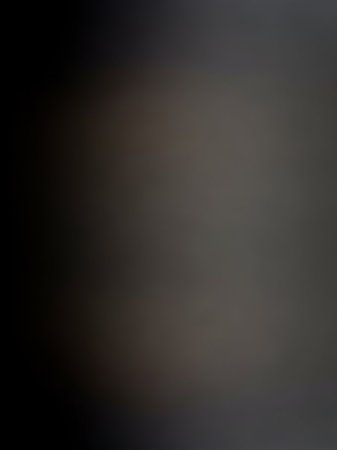 Field showing softly blurred dark gray and black abstract background with subtle variations in tone and light creating a moody and atmospheric effect keywords:...の素材