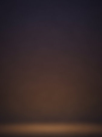 Brown showing subtle gradient of deep indigo and warm brown tones fading into a softly illuminated horizon line at dusk or dawn. resolutionの素材