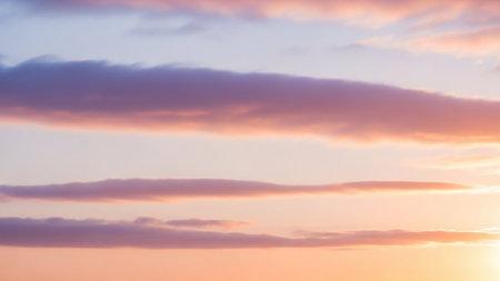 Orange showing soft pastel sunset sky with horizontal streaks of pink orange and purple clouds creating a gentle gradient effect keywords: sunset, sky, clouds,...の素材