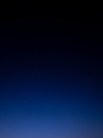 Simple showing deep gradient of dark navy blue transitioning to a lighter, vibrant royal blue at the bottom of the frame creating a smooth, atmospheric background...の素材