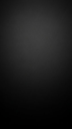 A smooth, dark black gradient background with a subtle texture and soft light fading from to bottom, various applications.の素材