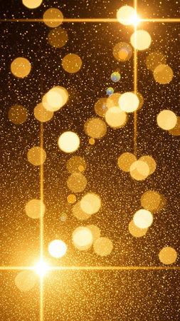 Abstract showing golden bokeh lights and sparkling glitter particles create a festive and magical abstract background with bright starbursts and soft glowing...の素材