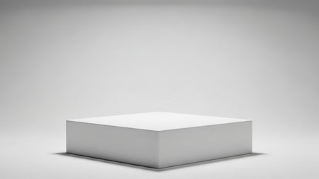A clean white square podium is centered on a seamless light gray background with soft shadows, creating a minimalist display space.の素材