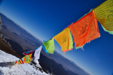 5 color flags on the top of the mountainの写真素材
