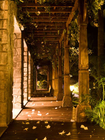 a wooden gallery in a resort with flowers on the roofの写真素材
