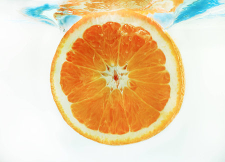 orange in water on a blue backgroundの写真素材