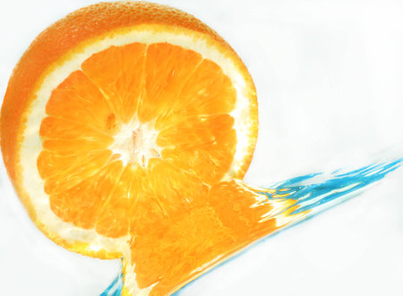 orange in water on a blue backgroundの写真素材
