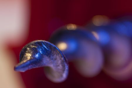 Cork Screw close up with red back groundの写真素材