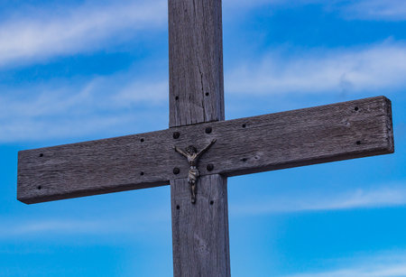 Wooden cross against the blue sky, symbolizing the crucifixionの写真素材