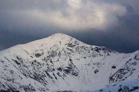 Snowy mountain peaks in the clouds. Caucasus Mountains, Georgia, region Gudauri.の写真素材