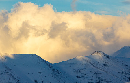 Beautiful winter mountains landscape with snow covered peaks and blue sky.の写真素材