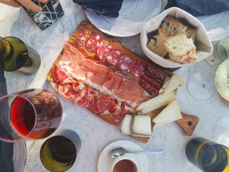 Cheese plate with prosciutto, salami and wineの写真素材