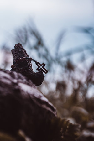 Wooden rosary with cross - with bokeh in backgroundの写真素材