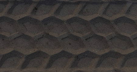 Wheel traces on the beach, shot parallel to the ground for background usageの写真素材
