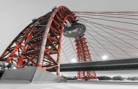 A modern red cable-stayed bridge over the Moskva riverのeditorial素材
