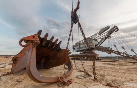 A giant rusty bucket in the background quarry excavator Equipment for the extraction of sand from the quarry.の写真素材