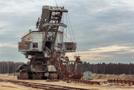 Many buckets of giant quarry excavator Equipment for the extraction of sand from the quarry. Front viewの写真素材
