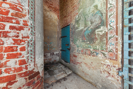 Old wooden blue door to the abandoned bell tower. Partially preserved ancient temple old Russian paintingの写真素材