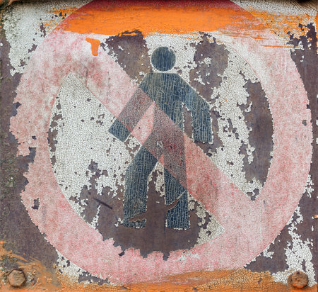 Faded and shabby sign of danger on a metal plateの写真素材