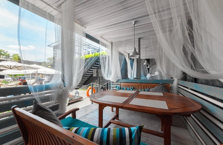 MOSCOW - JULY 2014: Interior of stylish Mediterranean cuisine Italian restaurant - "SILLYCAT". Covered veranda in a nautical style. Cabin with a table and tableのeditorial素材