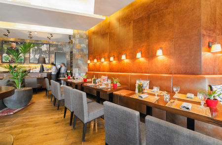 MOSCOW - JULY 2014: Interior of the modern Azerbaijani cuisine ethnic restaurants - "BARASHKA". Long leather corner sofa with tables in the main hallのeditorial素材