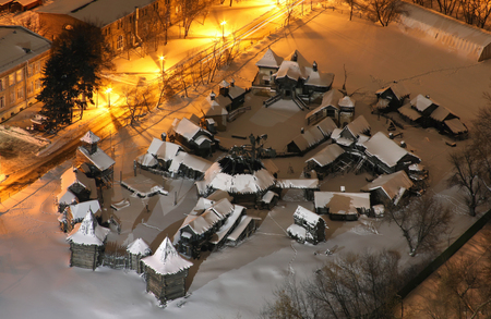 The scenery of the wooden Slavic village in full size with snow, at night. View from aboveの写真素材