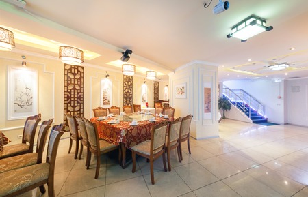 MOSCOW - AUGUST 2014: Interior of Chinese cuisine restaurant "HARBIN" in the traditional style. Hall served with a large tableのeditorial素材