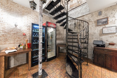 MOSCOW - AUGUST 2014: The interior Italian pizzeria "PORTO POMODORO". Metal spiral staircase with forged elementsのeditorial素材