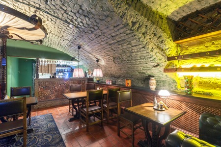 MOSCOW - AUGUST 2014: Interior of a luxury restaurant "PEPPE" in the historic cellar with brick vault. The tables near the bar decorated with mosaicのeditorial素材