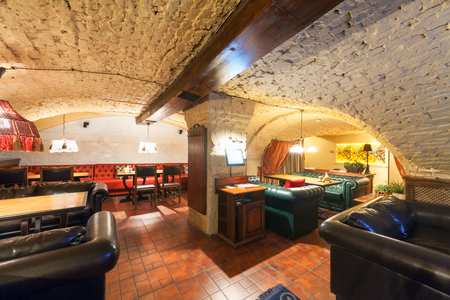 MOSCOW - AUGUST 2014: Interior of a luxury restaurant "PEPPE" in the historic cellar with brick vault. The main hall with leather sofasのeditorial素材