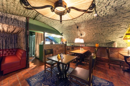 MOSCOW - AUGUST 2014: Interior of a luxury restaurant "PEPPE" in the historic cellar with brick vault. The tables near the bar decorated with mosaicのeditorial素材