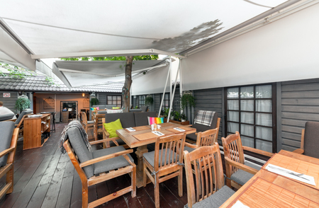 MOSCOW - AUGUST 2014: Interior elegant city restaurant "RULET". Patio restaurant under the tent with tablesのeditorial素材