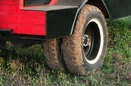Muddy dual wheel retro truck closeup in a countrysideの写真素材