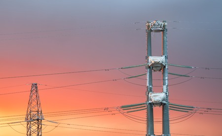 High voltage power transmission line on sunset backgroundの写真素材