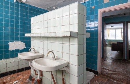 Bathroom with wash hand basin in the abandoned building of the children's pioneer campの写真素材