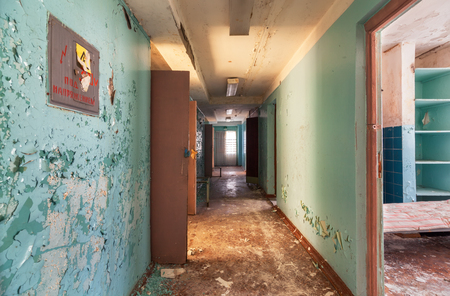 Corridor with open doors in an abandoned building of a children's health campの写真素材