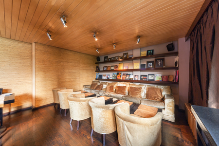 MOSCOW - AUGUST 2014: Interior is luxurious and fine dining restaurant "GALLERY". Long sofa near the wall with shelves and booksのeditorial素材