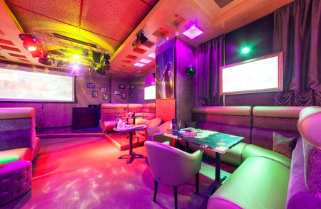 MOSCOW - AUGUST 2014: Modern interior of the main hall of the restaurant-karaoke "BRUSOFF". Table with high angular sofaのeditorial素材
